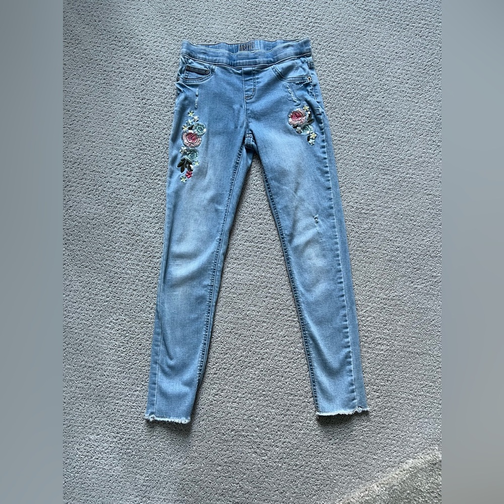 Justice mid rise jean leggings with floral accents.